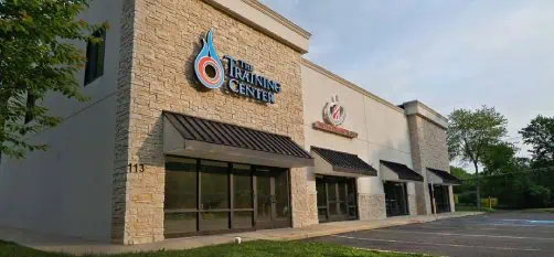 Building exterior with ‘The Training Center’ signage and large windows. Building exterior with ‘The Training Center’ signage and large windows.