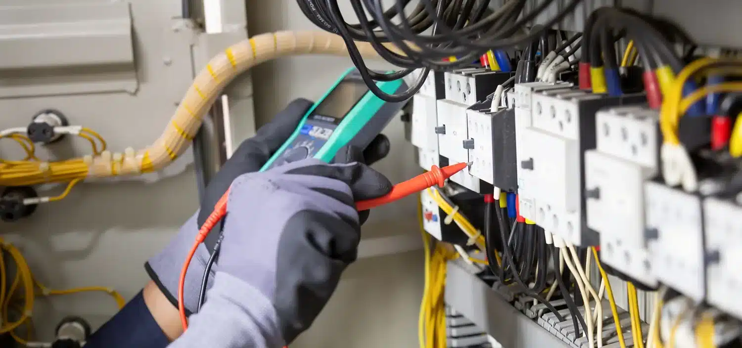 Engineer checking industrial pressure gauges in a facility