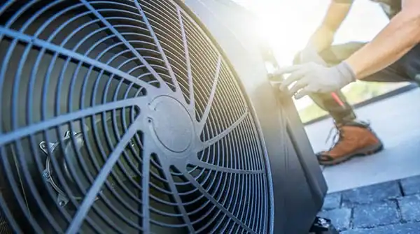 Technician adjusting HVAC system for optimal performance