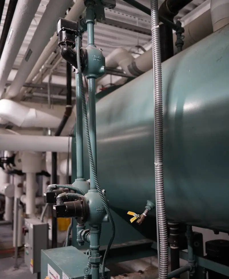 Industrial piping with valves and gauges in a mechanical facility.