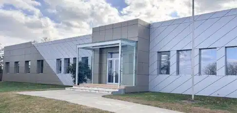 branchburg Modern building with glass entrance and paved walkway under a cloudy sky.
